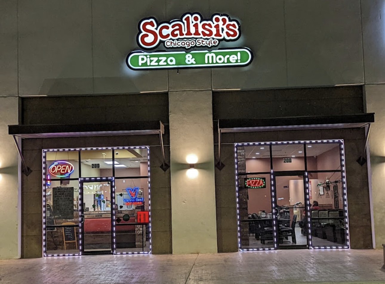 Scalisi's Chicago Style Pizza & More storefront glowing at night